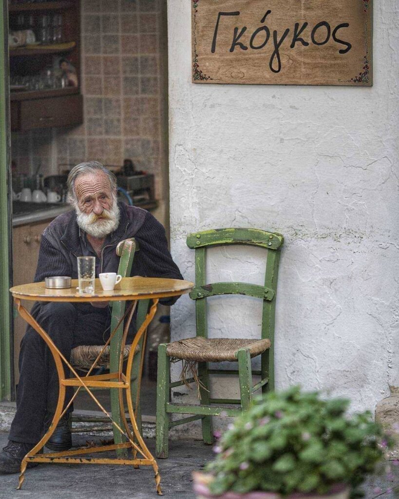 A Cretan man enjoying Greek coffee at a taverna in Anogeia, Crete.