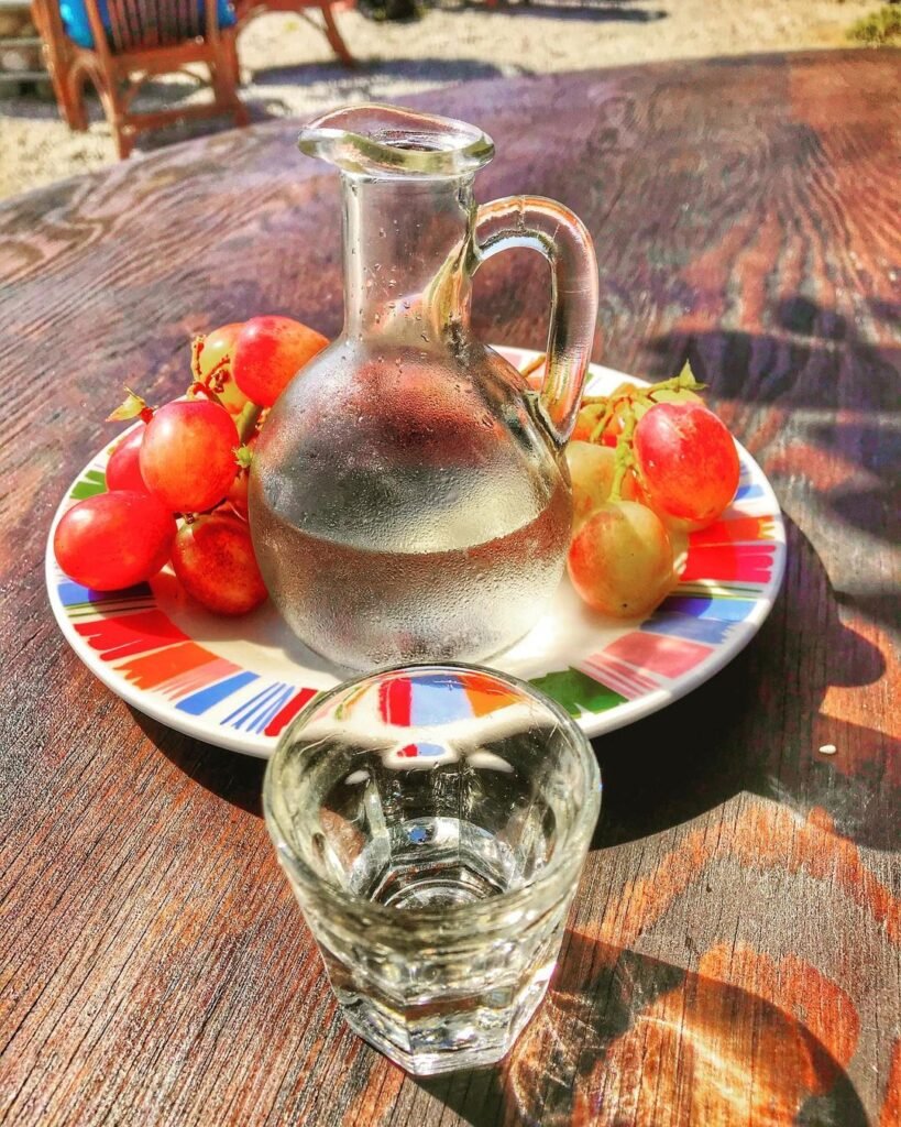 Cretan hospitality shown through offering dessert and homemade Cretan raki on the house at the end of a meal in Crete.