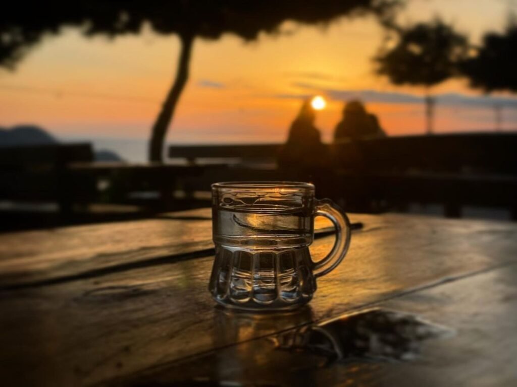 Cretan raki with a delightful sunset backdrop. 