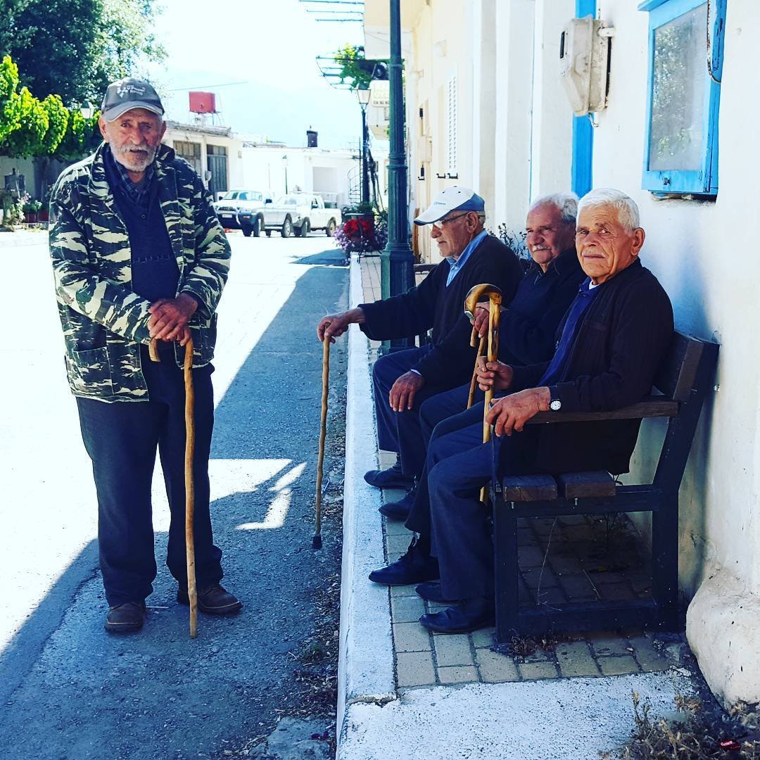 Cretans gathering for a warm afternoon chat in the heart of Mesa Lasithi, Crete.