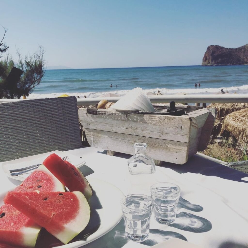 Tsikoudia served with fresh watermelon on a hot summer day in Crete.