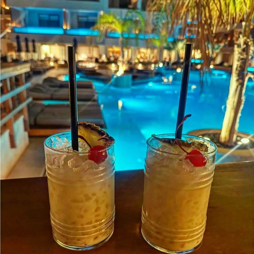 Drinks by the pool at Akasha Beach Hotel and Spa, Hersonissos, Heraklion, Crete, Greece.