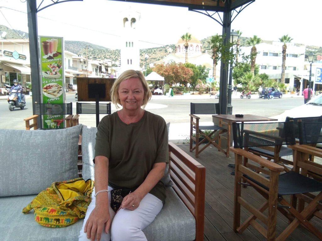 Juliet Carolan, author of "Footsteps of Fate", relaxing at Eden Cafe, Elounda, Crete.