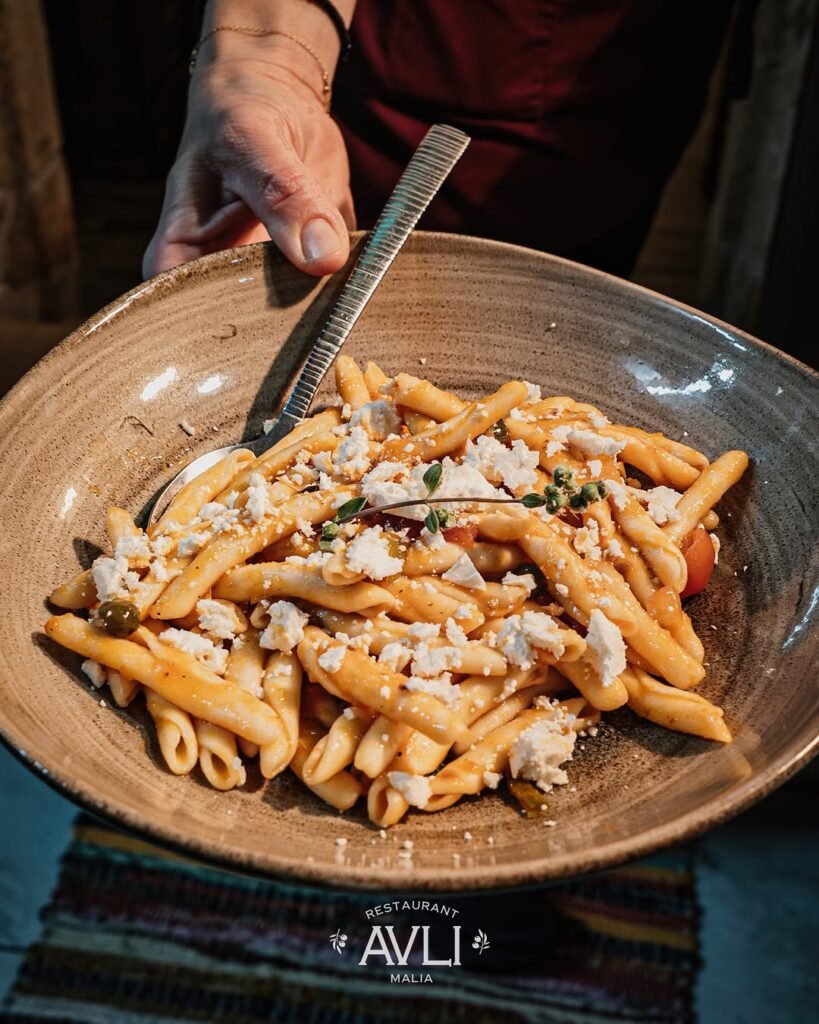 Cretan Skioufichta, with a rich sauce of fresh tomato, capers, olives, fresh onion, and grated Cretan cheese at Avli Malia, Crete, Greece.