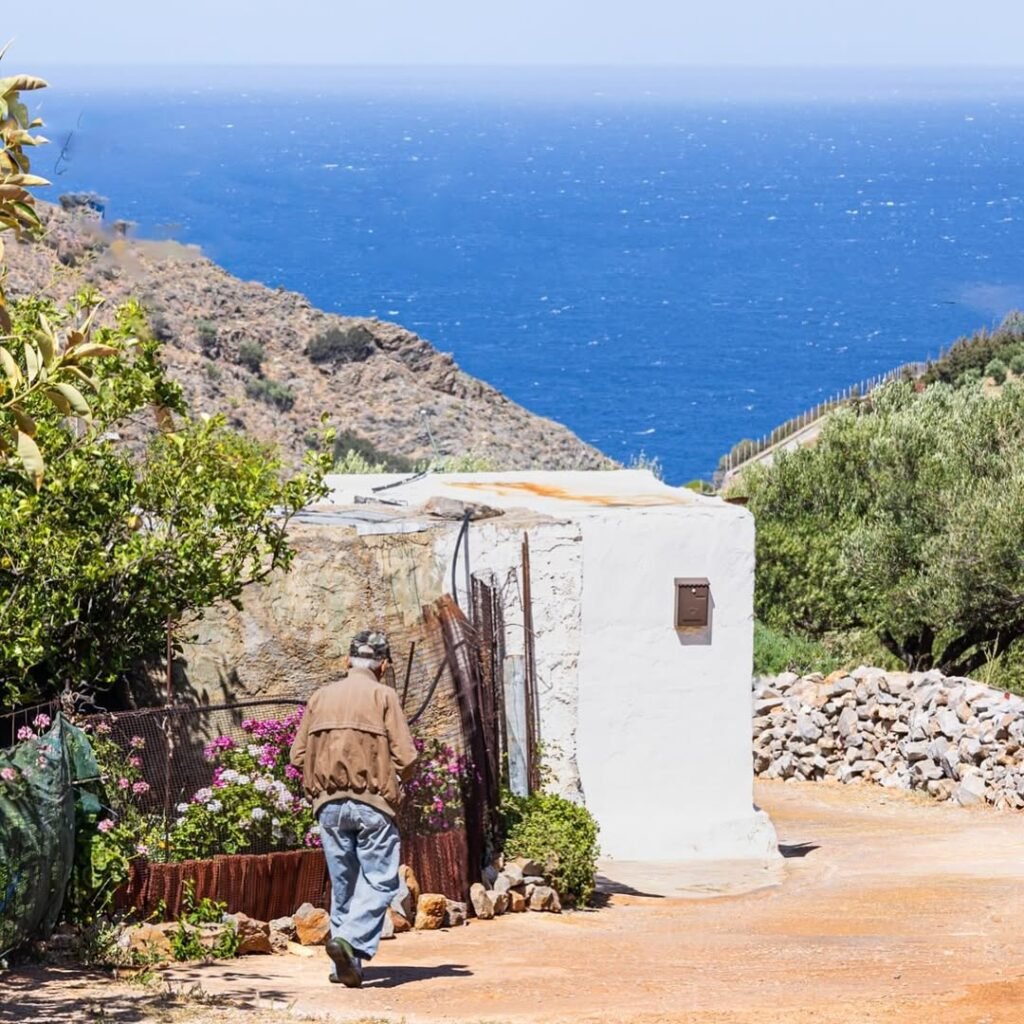 A glimpse of simple village life in Crete, Greece, as a Cretan man strolls along his path. 