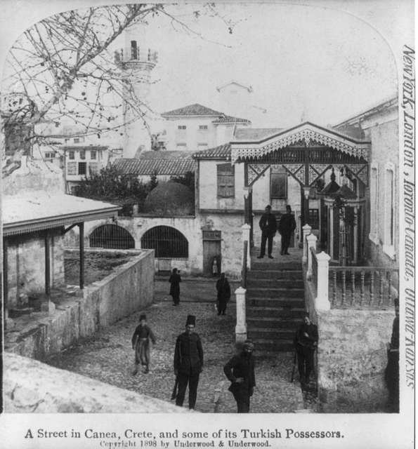 A street in Crete, and some of its Turkish possessors. Photo copyright 1808 by Underwood & Underwood. 