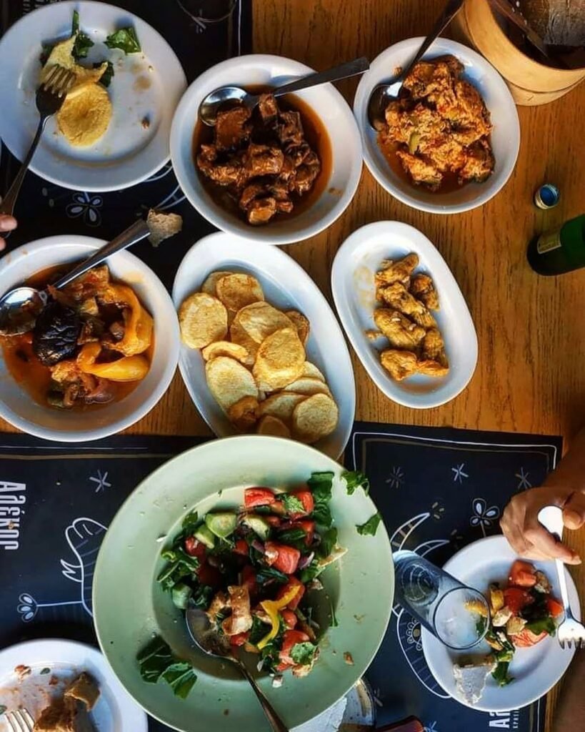 The traditional Cretan approach to dining features shared Greek mezedes (small plates) placed at the center of the table—a communal eating style that reflects the island's deeply social approach to meals.