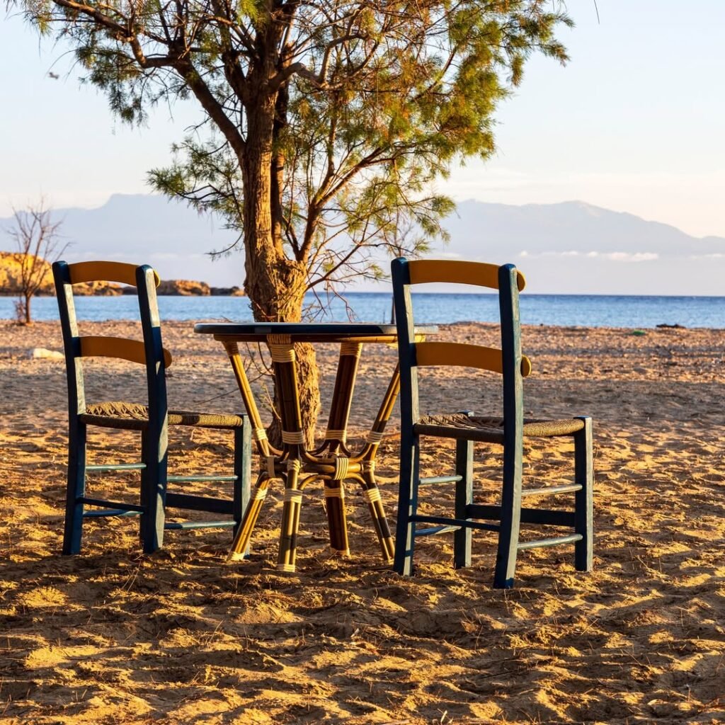 Simple pleasures at Sarakiniko Beach – where time slows down, chairs sink into golden sand, and the sea is always just a few steps away. 