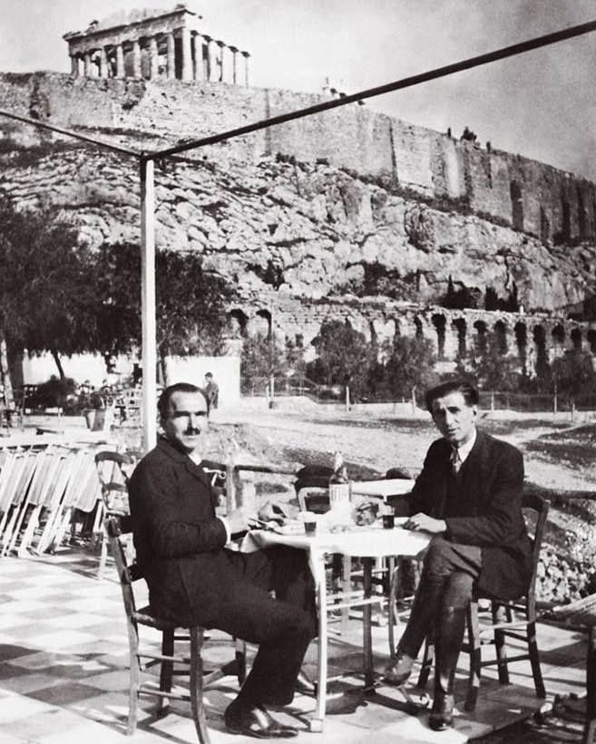 Nikos Kazantzakis (left) and Panait Istrati enjoy a moment in Athens, with the iconic Acropolis standing behind them—a meeting of literary minds beneath the weight of history.
