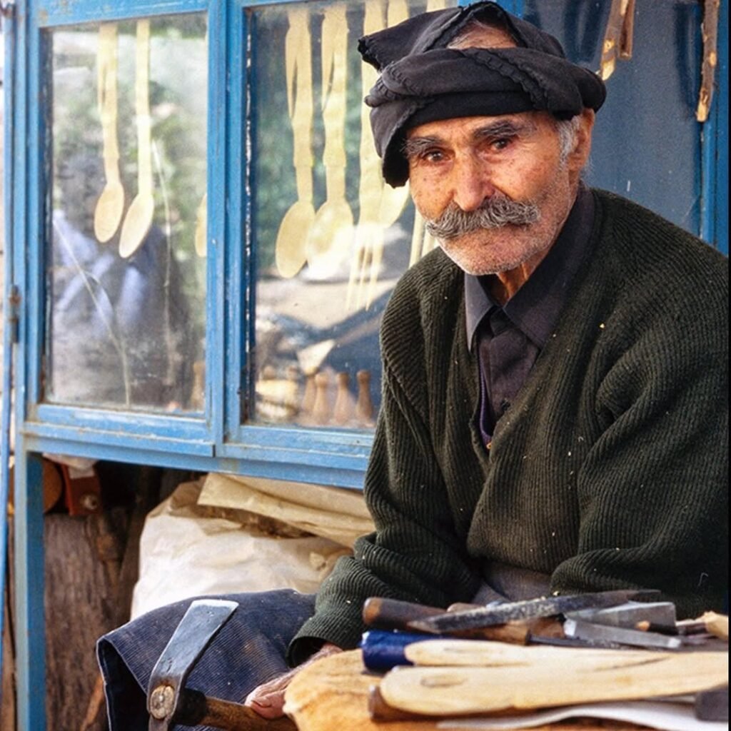 Spoon carver Brokomanolis from Zenia, Agios Nikolaos, captured by Swiss photographer Wolfgang Bernauer in his book My Greek Village, which documents a disappearing rural world.