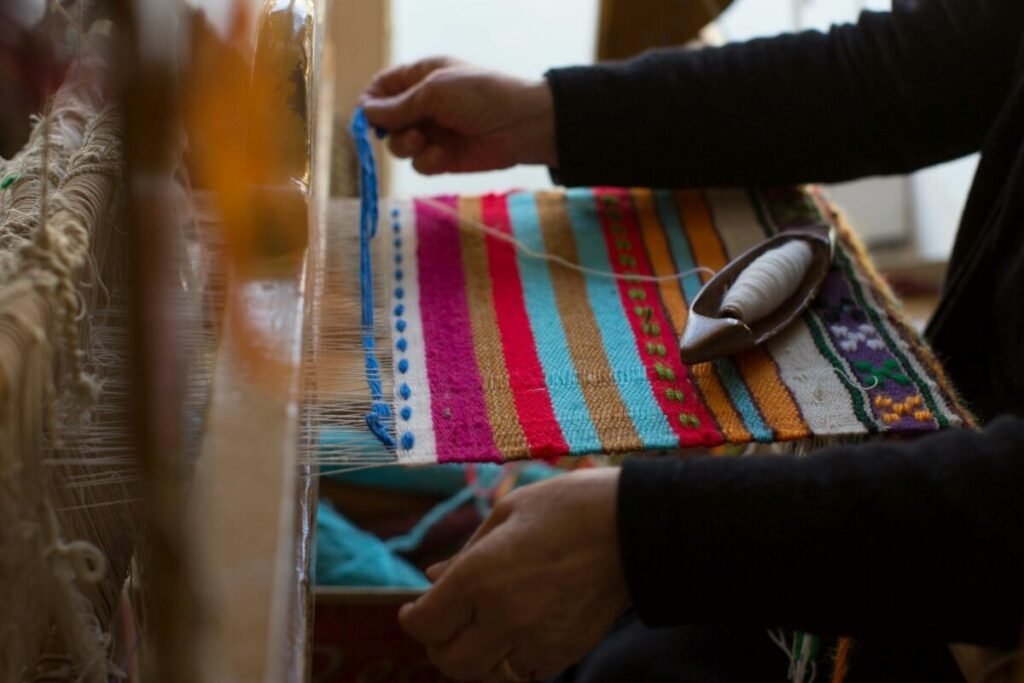 Colorful threads come to life on the loom—an intimate look at one of the most enduring crafts in Crete, where tradition is woven with every pass of the shuttle. 