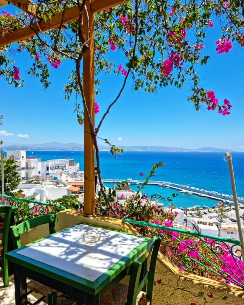 A peaceful taverna view overlooking the harbor of Agia Galini — the perfect place to pause during your Crete road trip and soak in the colors of the Libyan Sea.
