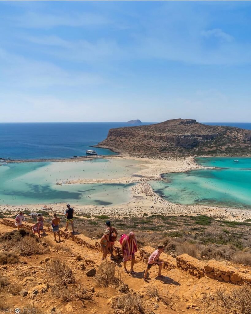 The hike down to Balos Lagoon rewards you with one of the most iconic views in Crete — turquoise waters, white sand, and dramatic cliffs all around. 