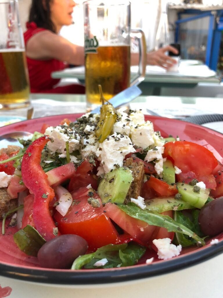 A Greek salad bursting with colour and freshness, served with cold beers at George’s Yard in Matala — a simple pleasure that hits the spot after a day by the sea. 