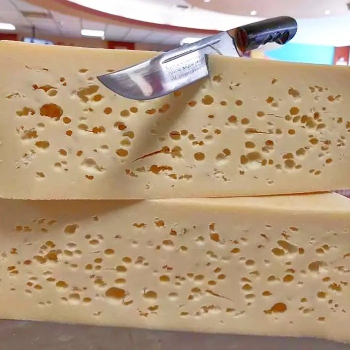 Those iconic holes and firm, golden texture can only mean one thing – authentic Graviera, the king of Cretan cheese. Aged to perfection.