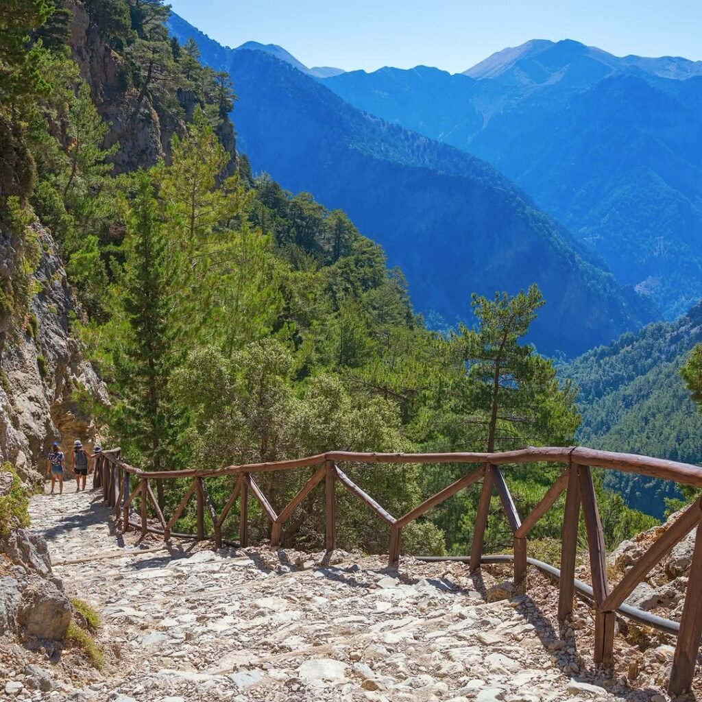 The scenic trail through Imbros Gorge winds between dramatic cliffs and pine-covered slopes — a quieter, shorter alternative to Samaria, but just as stunning.