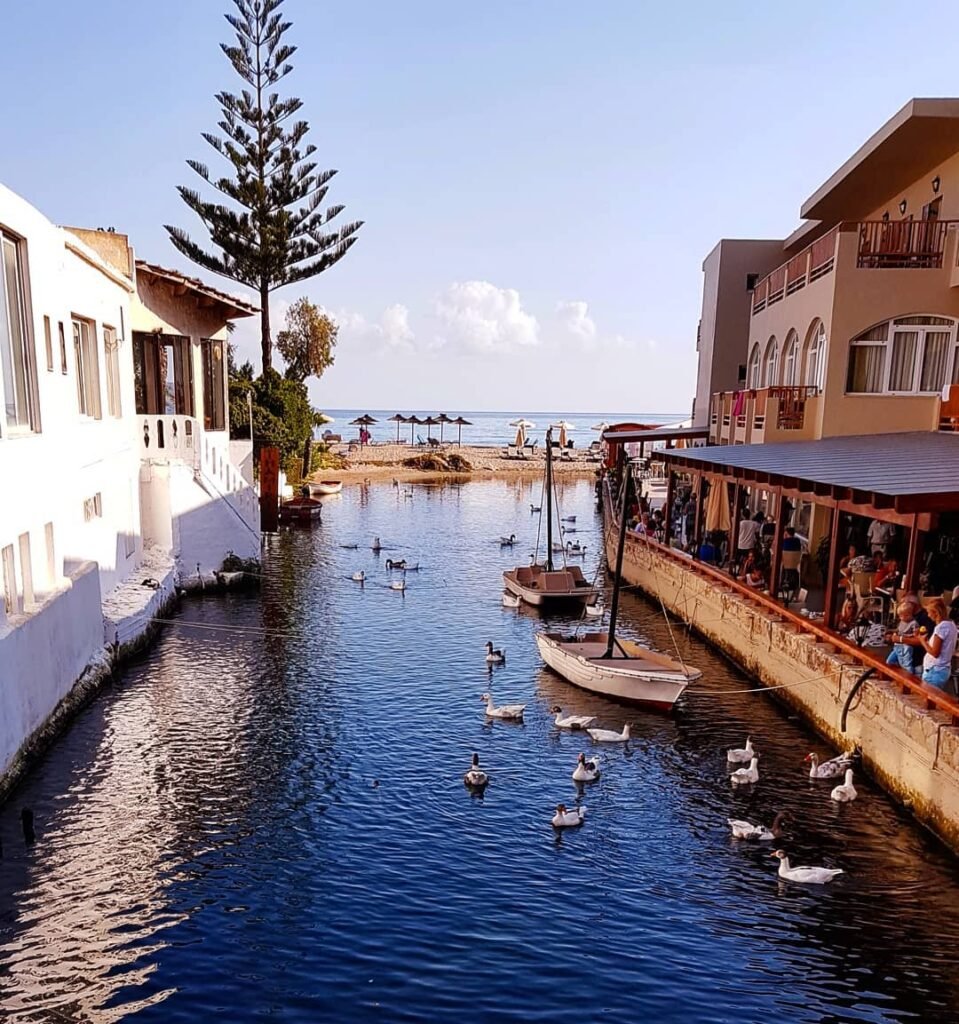 Where else can you enjoy a beach day with ducks? At Kalyves Beach, the Xydas River flows gently to the sea, creating a peaceful spot loved by locals—and their feathered friends. 