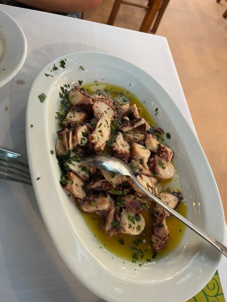 Tender octopus in olive oil and herbs at Stelios & Katina in Kissamos — a deliciously simple Cretan dish that's perfect after a day of coastal exploring. 
