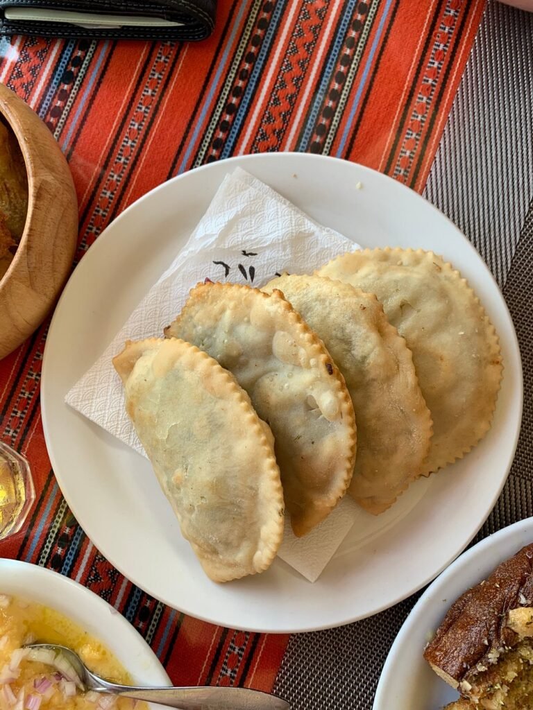 Golden, crispy kalitsounia straight from the kitchen at Taverna Nikos — these traditional Cretan pastries are often filled with wild greens, cheese, or herbs, and always full of flavour. 