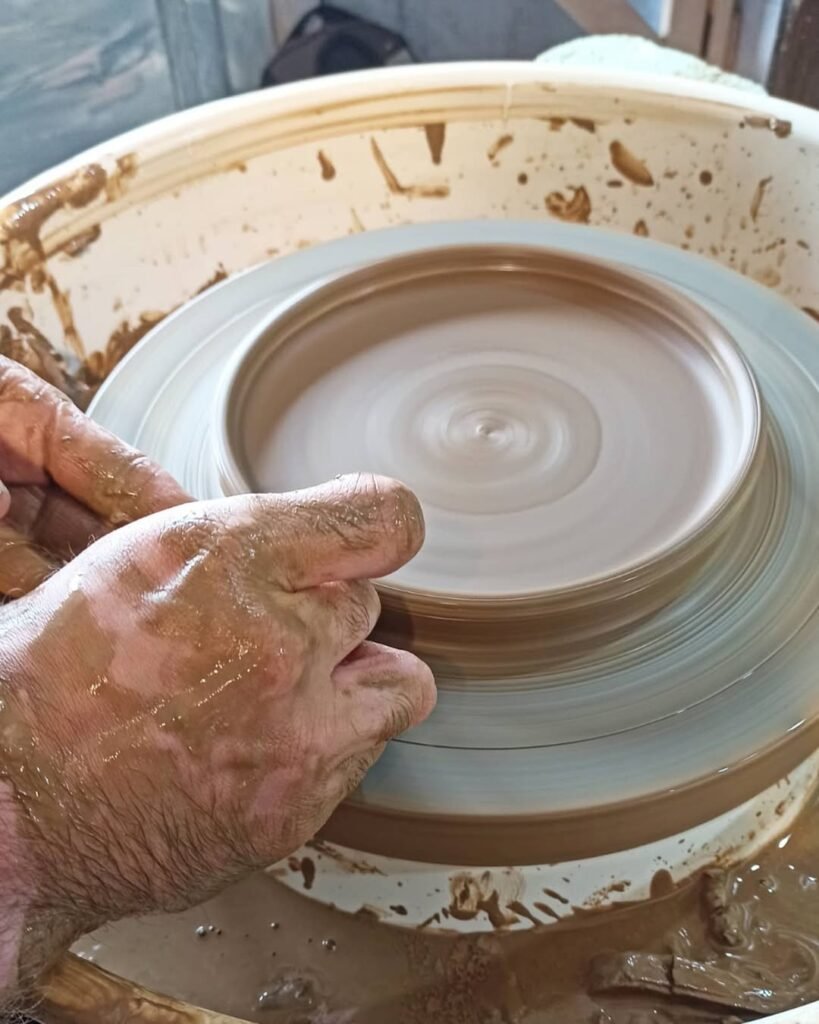 Skilled hands shape Crete’s ancient tradition, molding wet clay into timeless artistry. 