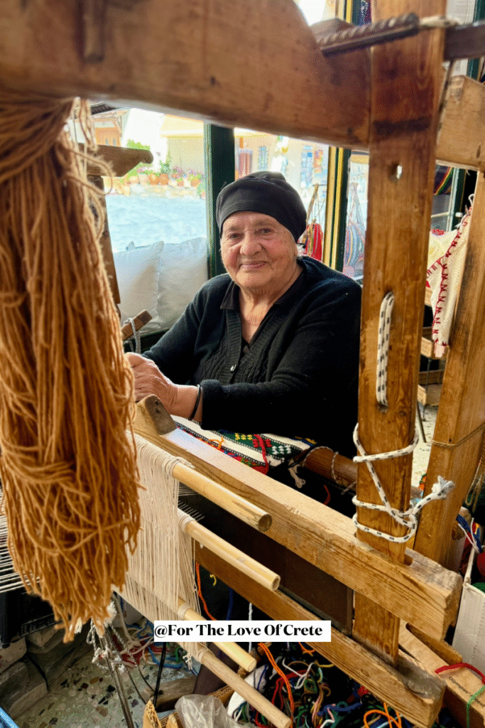 This is Aristea Xilouris, cousin of the legendary Cretan singer and lyra player Nikos Xilouris. I had the pleasure of meeting her in Anogeia, Crete, where she continues her life's work as a master weaver. As she worked at her loom with natural wool, she shared how she insists on using traditional materials, unlike the synthetic fabrics often found in Heraklion. 'Everything here is handmade,' she told me, with quiet pride.