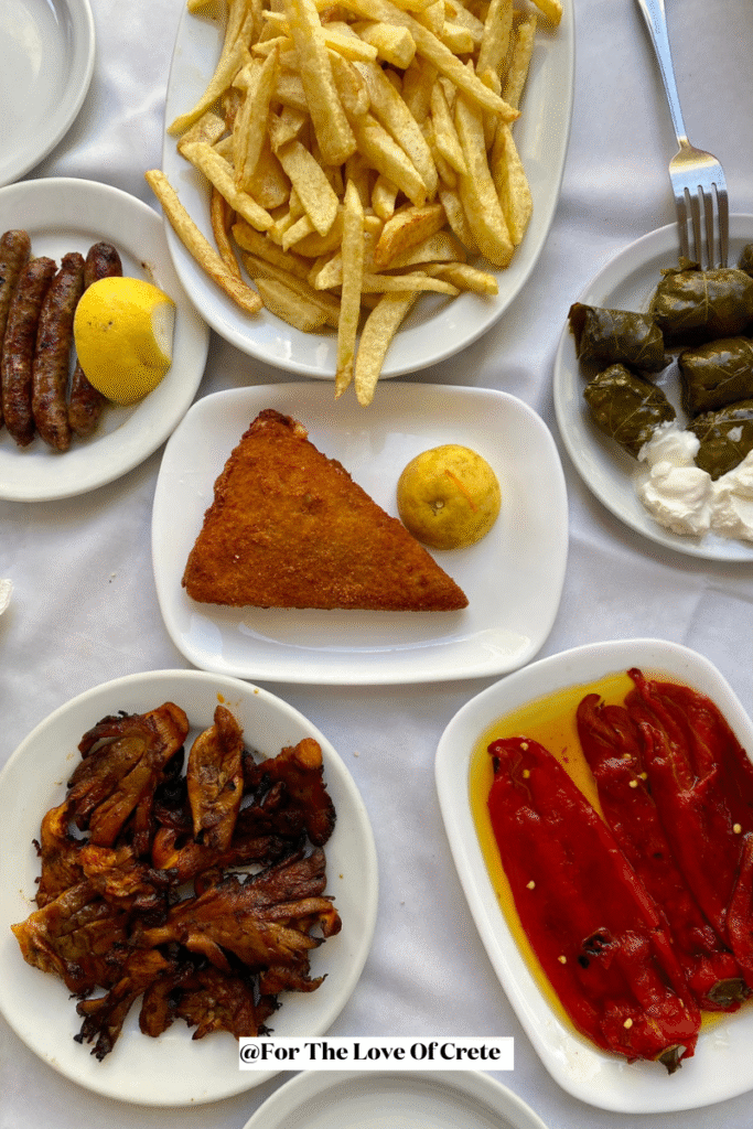 A table full of traditional Cretan favourites at Apokoronas Restaurant, one of the most authentic local spots in Chania Town. Photo Credit: For The Love Of Crete.