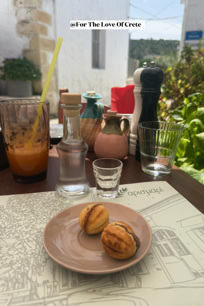 At Arismari Taverna in Gavalochori, complimentary raki and a sweet treat, offered with genuine Cretan hospitality. 