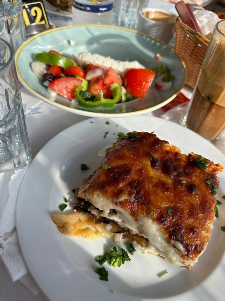 Classic moussaka and a fresh Greek salad served under the Cretan sun at Irene Restaurant.