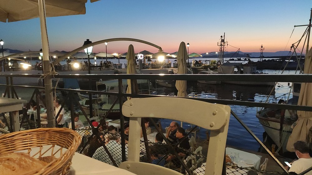 Sunset views by the sea at Manos Fish Taverna in Nea Chora—one of the best places in Chania for fresh seafood with a local vibe.