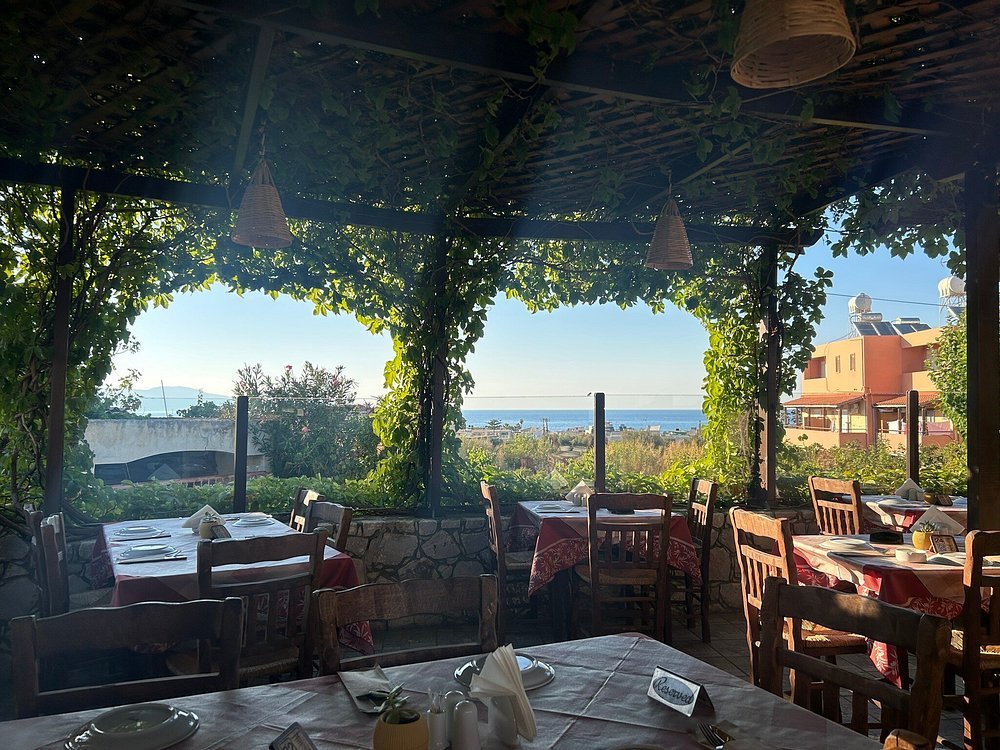 Shaded terrace with sea views at Meraki Taverna in Agia Marina, one of the most charming restaurants in Chania.