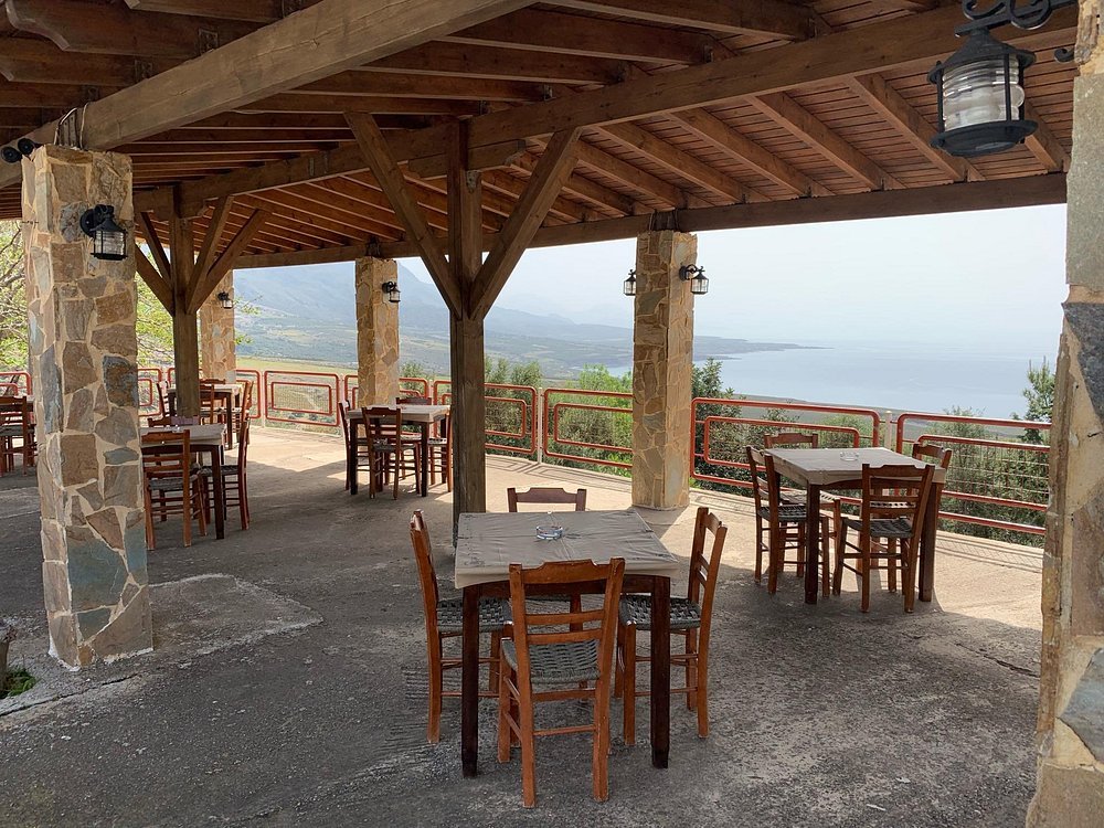 The peaceful terrace at Posidonio Cretan Cuisine in Komitades, with sweeping views over the sea and mountains.