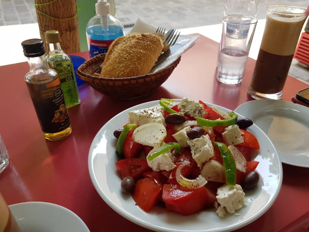 ChatGPT said:At Taverna Aristidis in Kritsa, a classic Greek salad with fresh tomatoes, creamy feta, olives, and local olive oil is the perfect start to an authentic Cretan meal. Photo Credit: Taverna Aristidis.