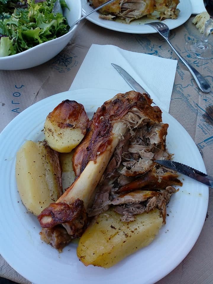 At Taverna Stefanis in Krasi, the slow-cooked lamb with roasted potatoes is a must-try, offering tender, melt-in-your-mouth flavors. Photo Credit: Taverna Stefanis.