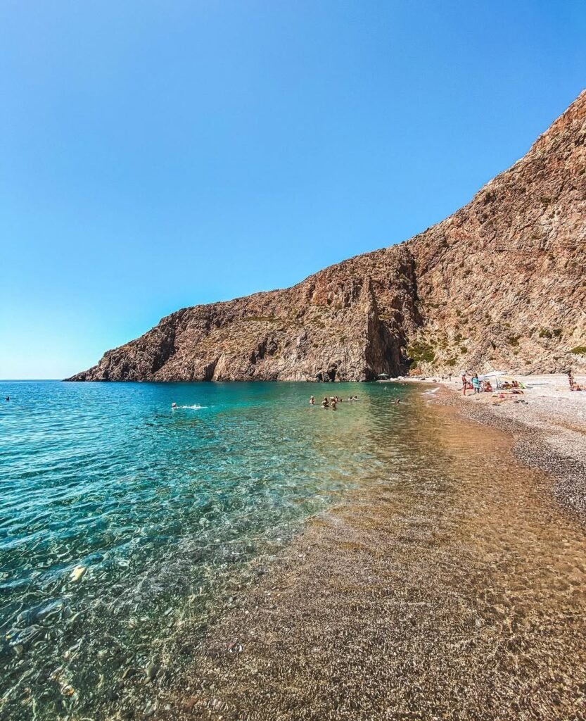 Agiofarago Beach reveals the sacred side of Crete's coastline, where towering cliffs once sheltered 300 Christian hermits in ancient caves. Among the most spiritually significant beaches in Crete, this "Gorge of the Saints" combines crystal-clear waters with centuries of history for an unforgettable adventure.