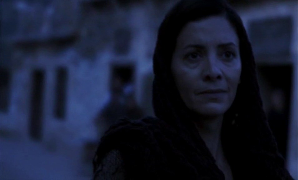 Eleni Petraki, the beloved schoolteacher of Plaka, faces the devastating moment of leaving her family and village behind as she departs for Spinalonga after her leprosy diagnosis. All rights to footage and images from 'To Nisi' (Το Νησί) belong to Mega Channel (MEGA TV).