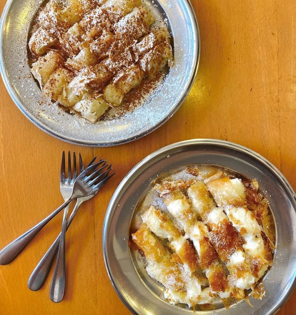 Fresh bougatsa, one of the most beloved Greek desserts, served hot with powdered sugar and cinnamon at Bougatsa Iordanis in Chania, Crete. 