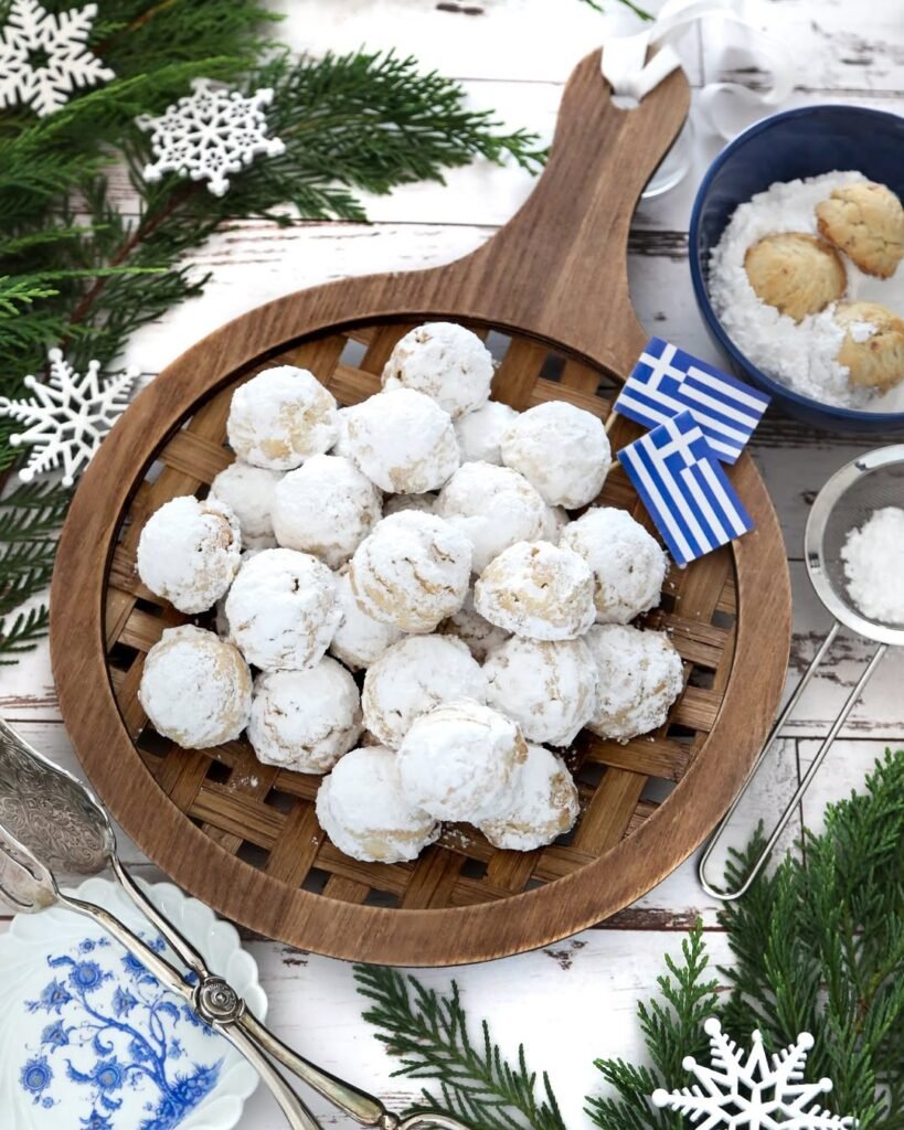 Buttery kourabiedes cookies generously dusted with powdered sugar, creating these melt-in-your-mouth Greek shortbread treats perfect for celebrations. 