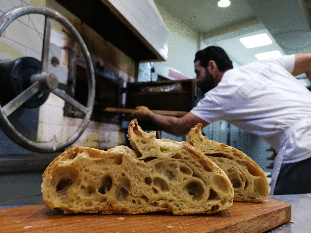 The signature sourdough bread at Kritikos Fournos Geuseis showcases the perfect crumb and crust that has made this one of Heraklion's most respected bakeries, where traditional natural fermentation creates bread worth the drive from anywhere on Crete.