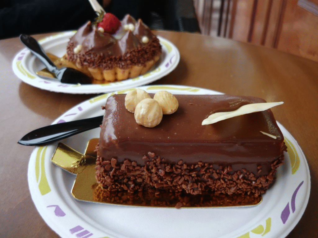 Exquisite chocolate cakes from Savoidakis Bakery featuring rich ganache, delicate decorations, and professional presentation that demonstrates why this family bakery has become synonymous with quality celebration desserts across Crete.