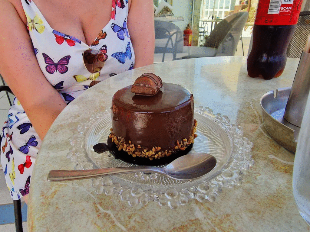 An elegant chocolate cake from Spyridakis Patisserie showcasing the meticulous attention to detail and five-star hotel quality presentation that has made this Kato Gouves establishment the gold standard for celebration cakes in the Heraklion region.