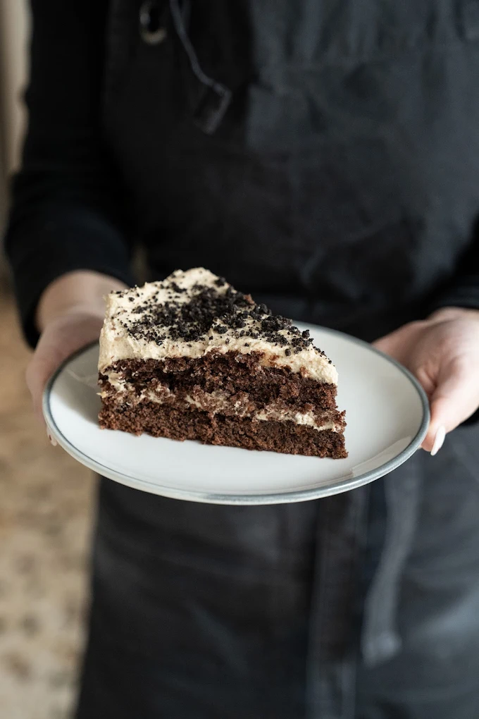 One of the artfully crafted cakes from Black Eyed Kate featuring rich chocolate layers and creamy frosting topped with cookie crumbles, showcasing the unique flavors and personal flair that have made this cake lab a beloved Chania destination. Photo Credit: Black Eyed Kate