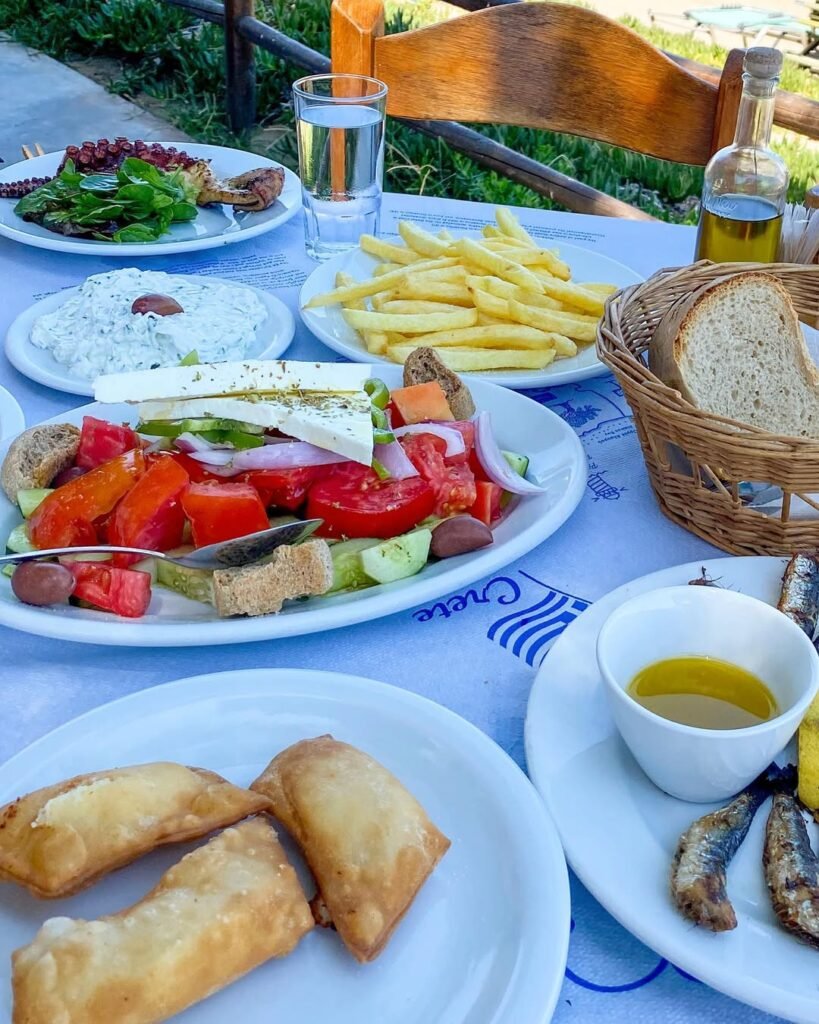 A Cretan table spread in Chania, where the tradition of feeding guests until they can't move traces back to Zeus Xenios, the god who protected strangers. 