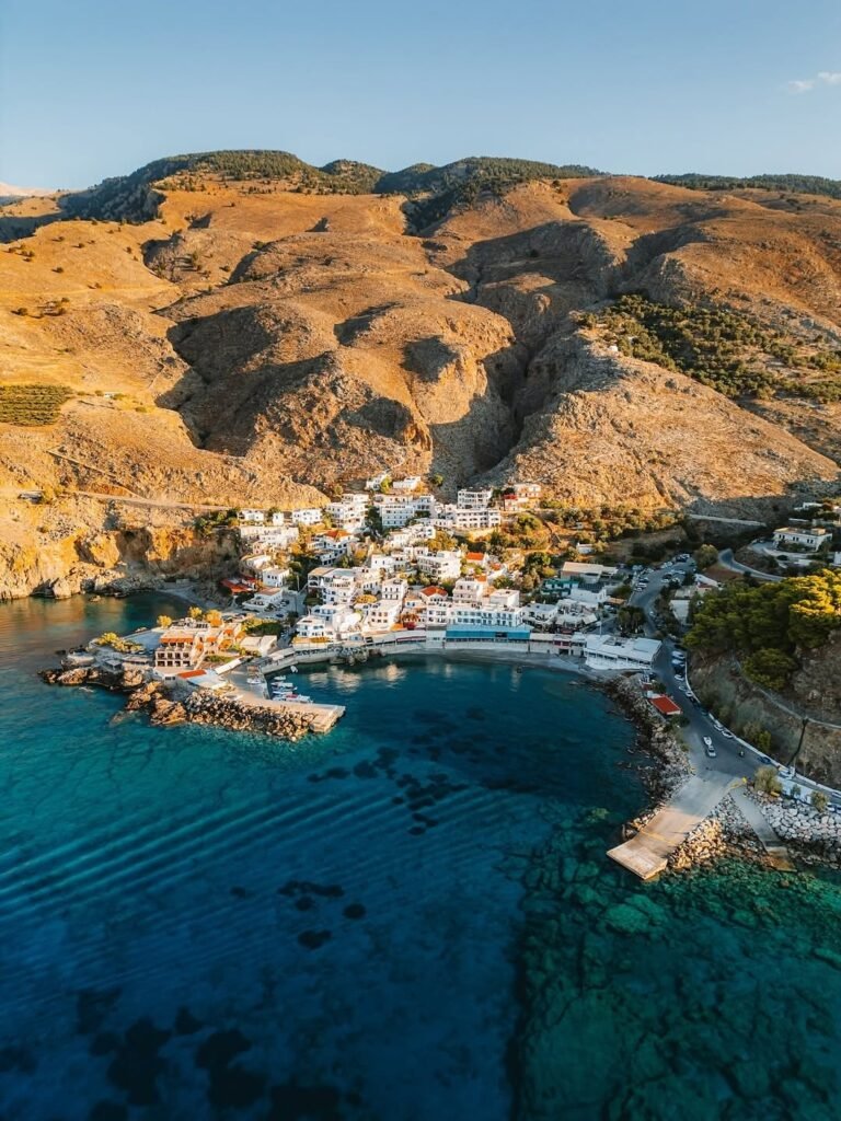 Hora Sfakion and its harbour, nestled between the Libyan Sea and the rugged slopes of the White Mountains. Photo Credit: @mary_quincy